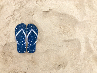 Flip flops on the beach sand.