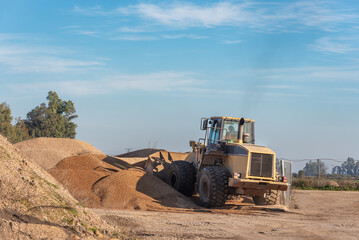 Excavator shovel moving sand in a quarry.