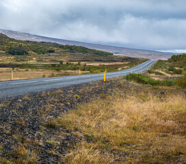 Gravel road and mountain view during auto trip in Iceland. Spectacular autumn Icelandic landscape with  scenic nature.
