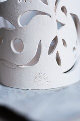 white clay openwork vase for dried flowers on a white background - obrazy, fototapety, plakaty