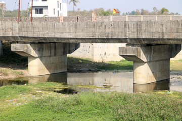Close-up view of bridge with pillar on river