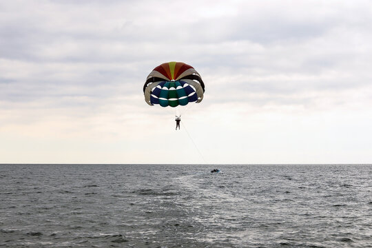 Skydiver enjoys a cloudy sky over the ocean