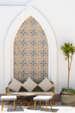 Arabian terrace exterior with sofas, tables, pillows and stools