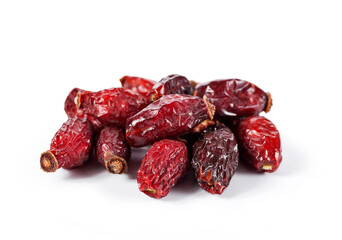 Heap of red dry rose hips isolated on a white background. 