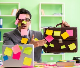 Businessman unhappy with many conflicting priorities sitting in