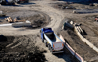 Truck and work equipment on a construction site