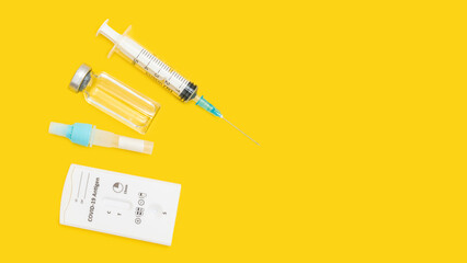 Rapid antigen test kit for viral disease COVID-19, top view on yellow background with copy space