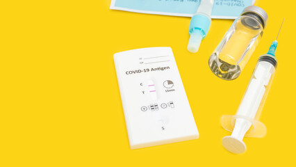 Rapid antigen test kit for viral disease COVID-19 with positive result, yellow background with copy space