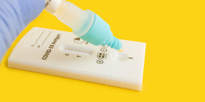 Process Of Testing With Rapid Antigen Test Kit For Viral Disease COVID-19 On Yellow Background