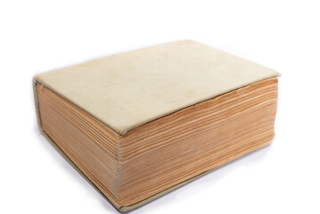 Old book with yellowed pages and a cloth cover. Thick book isolated on a white background.