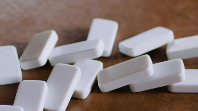 Dominoes in a pattern are pushed over, creating a falling chain reaction