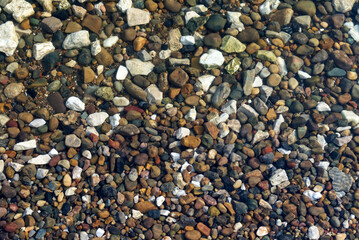 River motley pebbles under a layer of water.