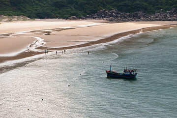 Aerial view of beautiful landscape, tourism boats, and people swimming on the sea, Vietnam. Travel concept