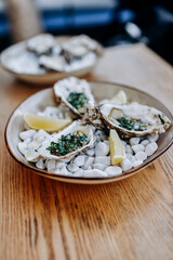 Fresh open oysters on a plate served with lemon