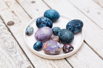 Colorful  Easter eggs on a light table. Eco-friendly products, Easter eggs colored with natural dyes 