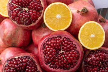ripe red pomegranates and oranges ready to be juiced