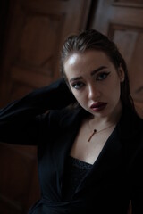 Fototapeta premium Portrait of a young girl. Elegant and melancholy portrait. Beautiful woman in classic clothes