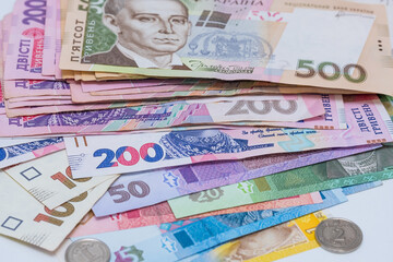 Ukrainian hryvnia and coins, background. Concept of receiving a salary, pension, inflation, deposit and credit. Concept of increasing the price of utilities, energy, gast