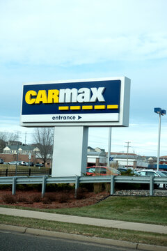 Large sign with arrow directing you to the CarMax place of business and used car lot specializing in online sales.  Maplewood Minnesota MN USA
