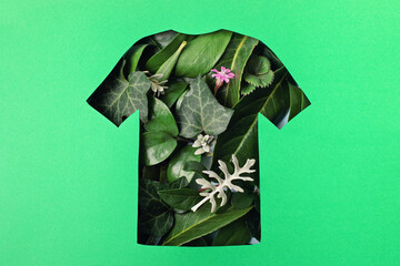 Paper cut t-shirt shape filled with green leaves. Organic cotton production, sustainable, ethical...