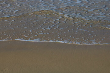 Soft sea wave on the sandy beach, background
