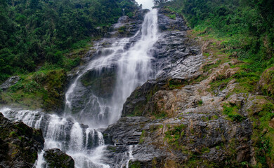 waterfall in the middle of a mountain 
