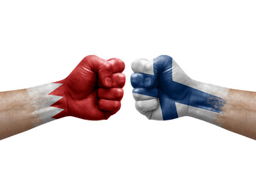 Two hands punch to each others on white background. Country flags painted fists, conflict crisis concept between bahrain and finland