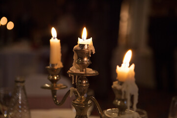 Candles in Candelabra with dripping wax and bokeh