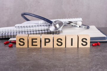 sepsis text on wooden blocks, medical concept, gray background