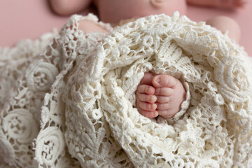 small feet of a newborn baby on a white background