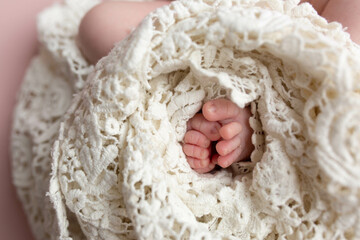 small feet of a newborn baby on a white background