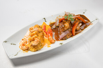 Paruvian food: Tacu tacu with sea food sauce and salted beef.