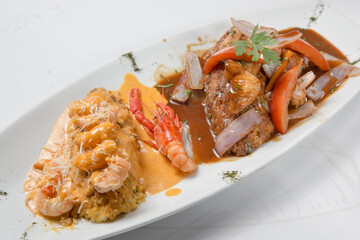 Paruvian food: Tacu tacu with sea food sauce and salted beef.