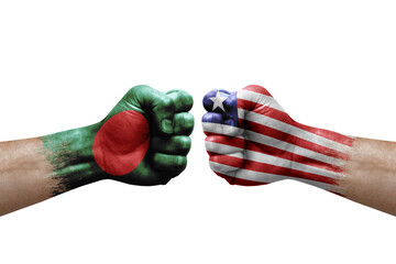 Two hands punch to each others on white background. Country flags painted fists, conflict crisis concept between bangladesh and liberia