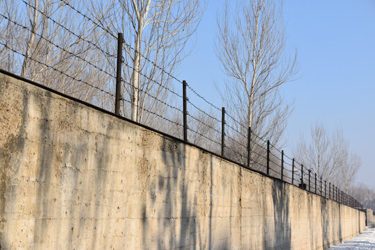 Wall and barbed wire fence of the Unit 731 building in Harbin, China. 