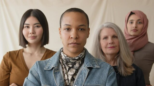 Slow motion of mid adult mixed race LGBTQ woman in support of International Women's Day with multi ethnic female friends