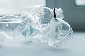 Clean empty crumpled plastic water bottles background. Waste management and plastic reuse concept. Macro texture