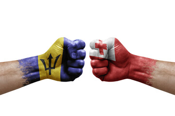 Fototapeta premium Two hands punch to each others on white background. Country flags painted fists, conflict crisis concept between barbados and tonga