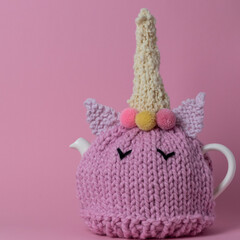 fun knitted pink unicorn tea cosy on a teapot