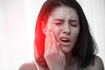 Problem with teeth. Woman Feeling a toothache. Close-up of a beautiful sad girl suffering from severe toothache.
