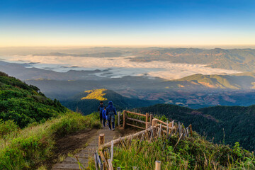 Tropical forest nature landscape view with toursits mountain range and moving cloud mist at Kew Mae Pan nature trail, Doi Inthanon, Chiang Mai Thailand - obrazy, fototapety, plakaty