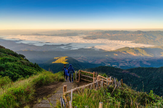 Tropical forest nature landscape view with toursits mountain range and moving cloud mist at Kew Mae Pan nature trail, Doi Inthanon, Chiang Mai Thailand
