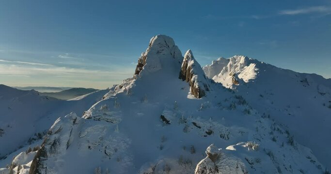 Fly over and around the mountains of Ciucas Romania in January 2022 Sunny day.