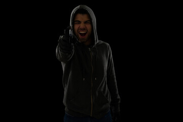 Fototapeta na wymiar Angry criminal committing robbery at gunpoint
