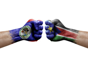 Two hands punch to each others on white background. Country flags painted fists, conflict crisis concept between belize and south sudan