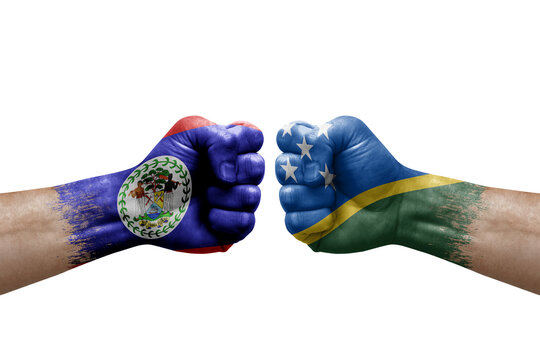 Two hands punch to each others on white background. Country flags painted fists, conflict crisis concept between belize and solomon islands