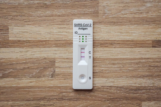SARS-CoV-2 rapid antigen test with two colored lines - positive result of coronavirus infection