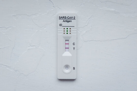 SARS-CoV-2 rapid antigen test with two colored lines - positive result of coronavirus infection