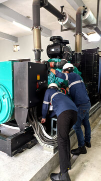 Technician engineer checking the performance of a diesel generator