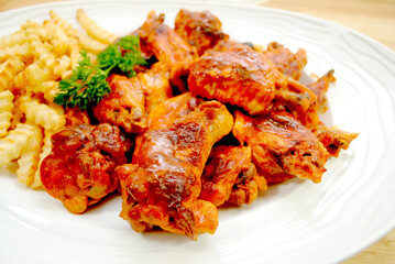 Close-Up of Spicy Baked Buffalo Wings Served on a White Platter